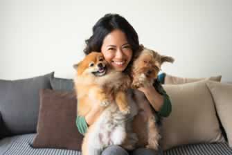 Cuddle and snuggle your dog or cat in our pet friendly Dayton apartments at Stillwater Park like the woman in this stock image
